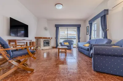 a living room with blue furniture and a fireplace at #350 Retiro do Abade by Home Holidays in Ferreiras