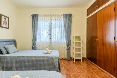 a bedroom with two beds and a window at #350 Retiro do Abade by Home Holidays in Ferreiras