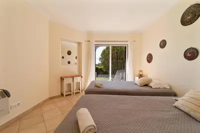 two beds in a room with a window at My Inzu by HelloVacations in Albufeira
