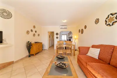 a living room with a couch and a table at My Inzu by HelloVacations in Albufeira