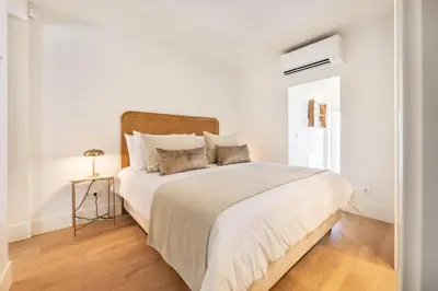 a white bedroom with a large bed with white sheets at BLQ Charneco 1BDR in Boliqueime by LovelyStay in Boliqueime