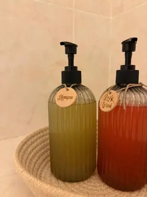 two bottles of soap sitting on top of a basket at Cozy and chic apartment in Albufeira
