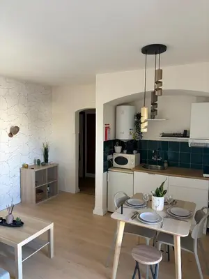 a kitchen and living room with a table and chairs at Cozy and chic apartment in Albufeira
