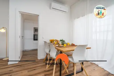 a kitchen and dining room with a wooden table and chairs at #281 Families Only -Telecomunicacoes Home Holidays in Albufeira