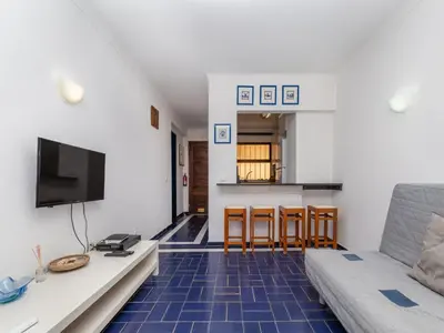 a living room with a blue tiled floor at Akisol Albufeira Eris in Albufeira