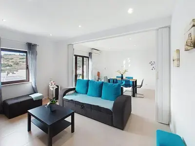 a living room with a couch and a table at Panorama Old Town sea view Albufeira in Albufeira