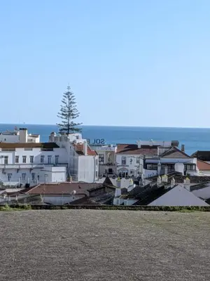 a group of buildings with the ocean in the background at Panorama Old Town sea view Albufeira in Albufeira