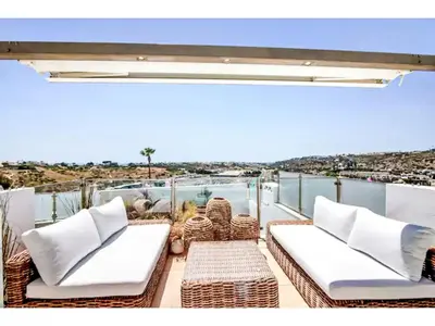 a balcony with wicker furniture and a view of the ocean at Holiday Home Gina - Sunny Way by Interhome in Albufeira