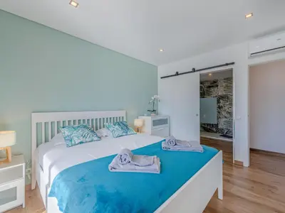 two beds in a room with blue pillows on them at Apartment Viva One - Vip Properties by Interhome in Albufeira
