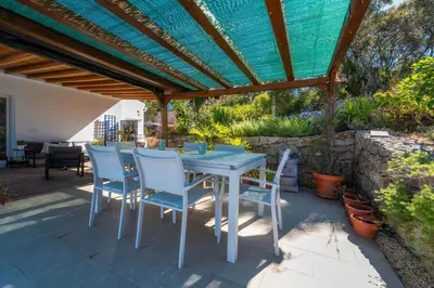 a house with a garage and a gravel driveway at Casa Colina Sonolenta in Fonte da Murta