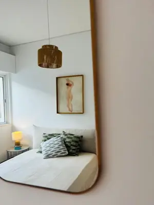 a mirror reflection of a bed in a bedroom at Casa Nico in Faro