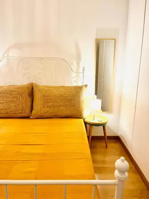 a bedroom with a bed and a mirror and a table at Casa Nico in Faro