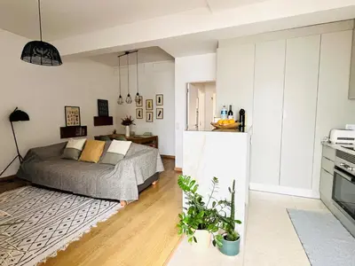 a living room with a bed and a kitchen at Casa Nico in Faro