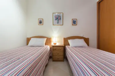 two beds sitting next to each other in a bedroom at vista golf in Quarteira
