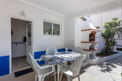 a dining room with a table and chairs at Blife Lucelya private rooms at Faro beach in Faro