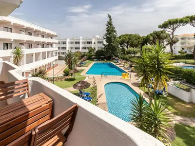 a view of the pool from the balcony of a hotel at Akisol Vilamoura Iron in Quarteira