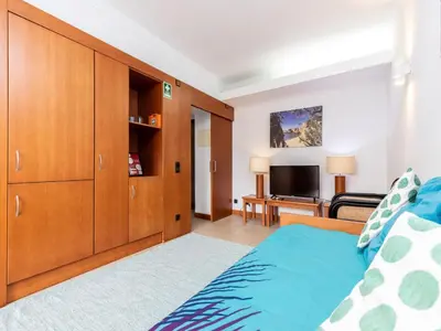 a bedroom with a bed and a tv at Akisol Vilamoura Iron in Quarteira