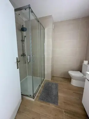 a bathroom with a shower and a toilet at Quarteira Atlantic View in Sesmarias