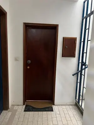a brown door in a room with a tile floor at Quarteira Atlantic View in Sesmarias