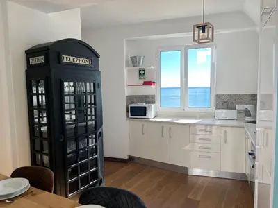 a kitchen with a black phone booth in a room at casa do cesar in Albufeira