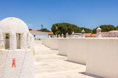 a white wall with a chain on it at Manelinha Apartment - cozy apartment with pool and beach in Quarteira