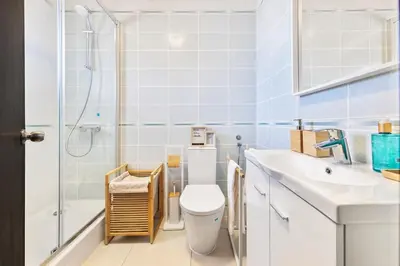a bathroom with a toilet sink and a shower at Manelinha Apartment - cozy apartment with pool and beach in Quarteira