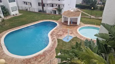 an overhead view of a swimming pool in a yard at Manelinha Apartment - cozy apartment with pool and beach in Quarteira