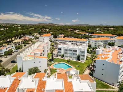 an aerial view of the buildings of a resort at Manelinha Apartment - cozy apartment with pool and beach in Quarteira