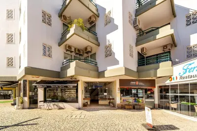 an apartment building with balconies and a store at Marina Family Apartment - Pool & Garage in Vilamoura