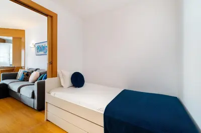 a bedroom with a large bed and a television at Marina Family Apartment - Pool & Garage in Vilamoura