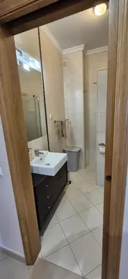 a bathroom with a sink and a mirror at Spacious 2 Bedroom Condo in Albufeira in Albufeira