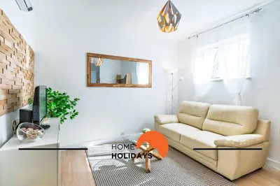 a living room with a couch and a mirror at #313 Travessa dos Arcos Flat by Home Holidays in Albufeira