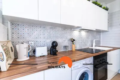 a kitchen with a stove top oven next to a microwave at #313 Travessa dos Arcos Flat by Home Holidays in Albufeira