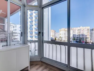 a room with large windows with views of a city at Apartamento Vida Pura com 2 quartos e vista mar in Quarteira