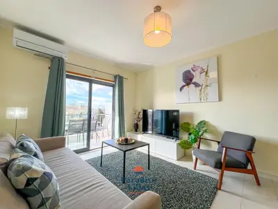 a living room with a couch and a tv at Two Bedroom Apartment with Sea Views in Albufeira in Albufeira