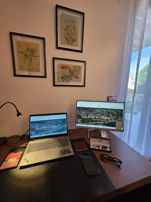 a desk with a laptop and a computer monitor at Casa dos sonhos em Vale do Lobo in Loulé