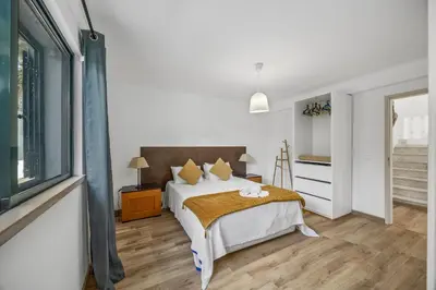 a bedroom with a bed and a sliding glass door at Joliet in Vilamoura