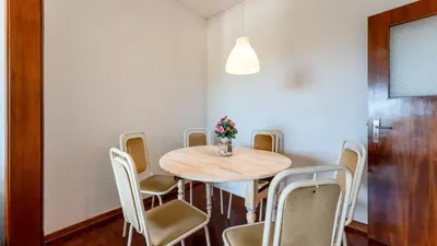 a dining room with a table and chairs at Cosy 3Bdr Flat near University by LovelyStay in Faro