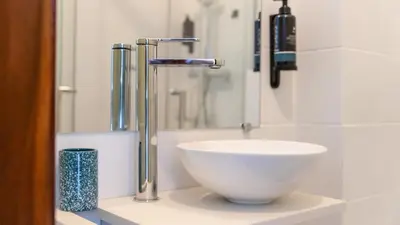 a bathroom with a sink and a faucet at Cosy 3Bdr Flat near University by LovelyStay in Faro
