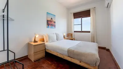 a bedroom with a bed and a window at Cosy 3Bdr Flat near University by LovelyStay in Faro