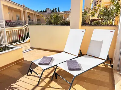 two chairs on a balcony with a table at Balaia Poolside House with Sea View by BeCherish in Atalaia