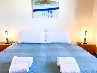 a bedroom with a bed with two towels on it at Balaia Poolside House with Sea View by BeCherish in Atalaia