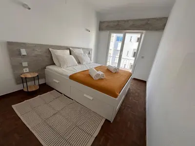 a bedroom with a bed with two towels on it at Pipos d'Al-buhera in Albufeira