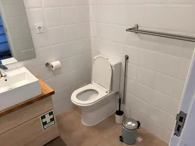 a bathroom with a white toilet and a sink at Pipos d'Al-buhera in Albufeira