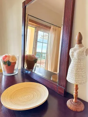 a mannequin and a plate on a table in front of a mirror at Balaia Maggs House Pool & Ocean view by BeCherish in Albufeira