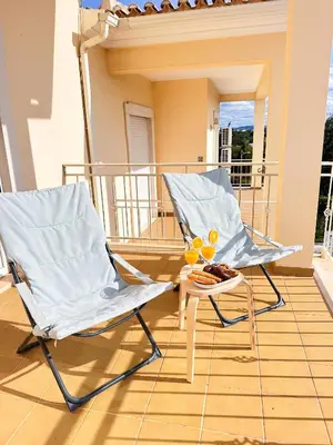 two chairs and a table on a balcony at Balaia Maggs House Pool & Ocean view by BeCherish in Albufeira