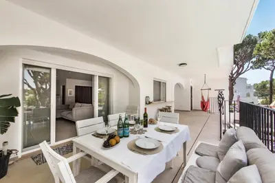 a dining room with a table and a couch at Casa Florida in Almancil