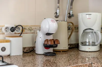 a white mixer on a counter in a kitchen at Peaceful 2Bdr with Pool in Vilamoura by LovelyStay in Quarteira