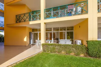 a large house with a balcony and a lawn at Peaceful 2Bdr with Pool in Vilamoura by LovelyStay in Quarteira