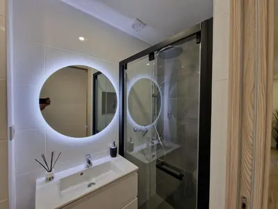 a bathroom with a sink and a shower at O&P Apartments in Faro